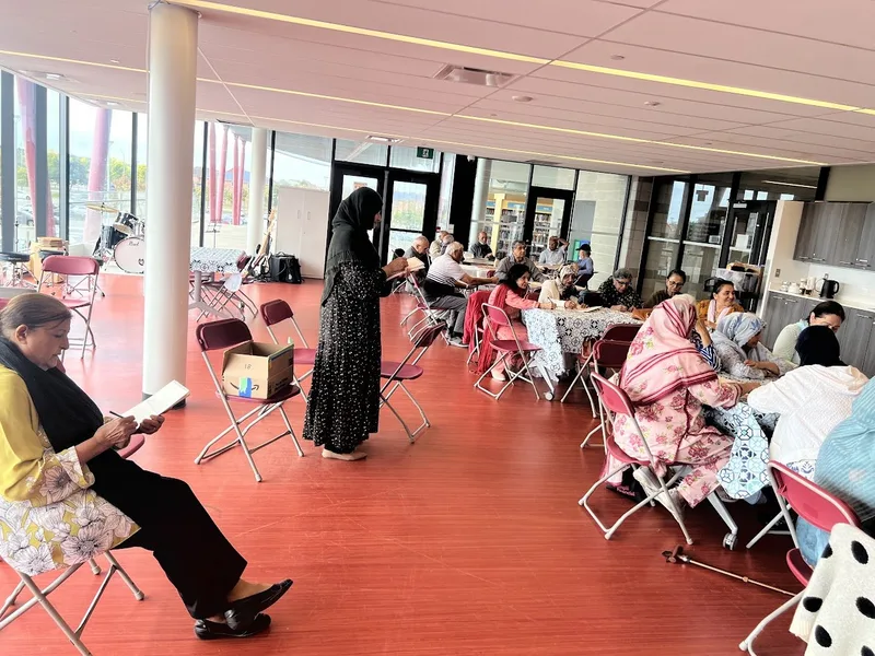 Participants gathered around tables at Aaniin Community Hub